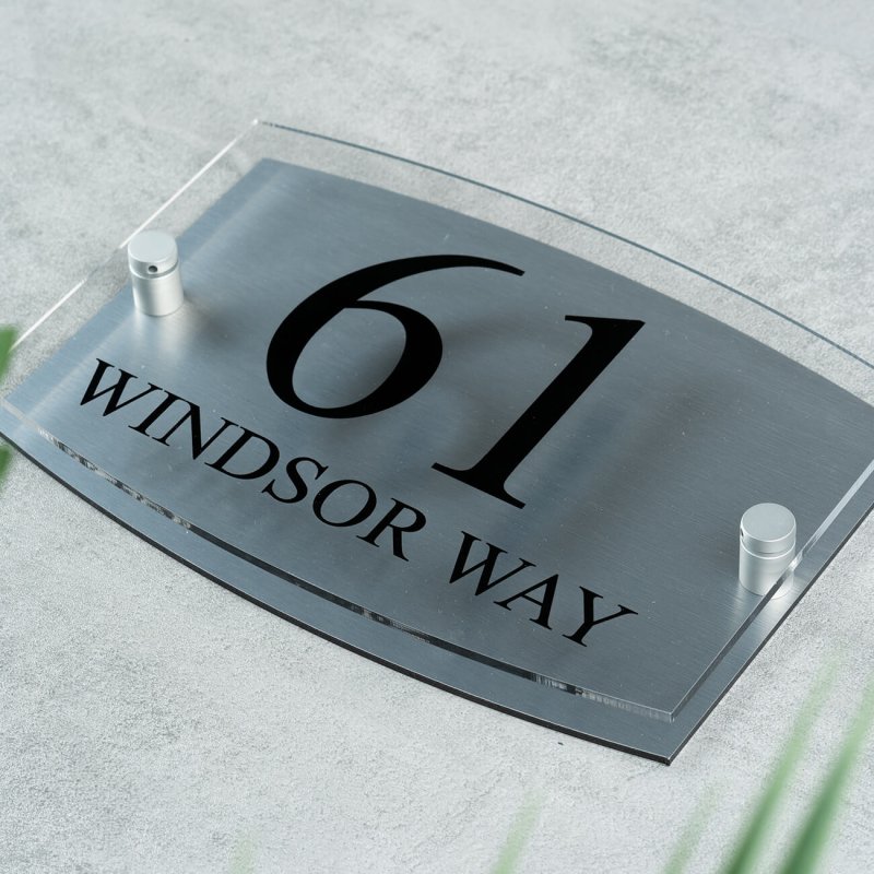 Premium quality acrylic house sign featuring text printed on a clear front panel in UV-cured inks. Ideal for enhancing property entrances with modern, durable, and weather-resistant designs.