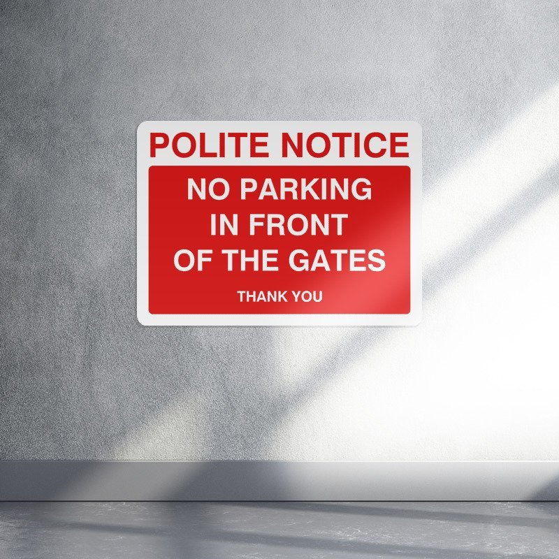 Polite notice no parking in front of these gates sign