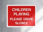 Children Playing Please Drive Slowly Sign