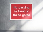 No Parking in front of these gates parking sign