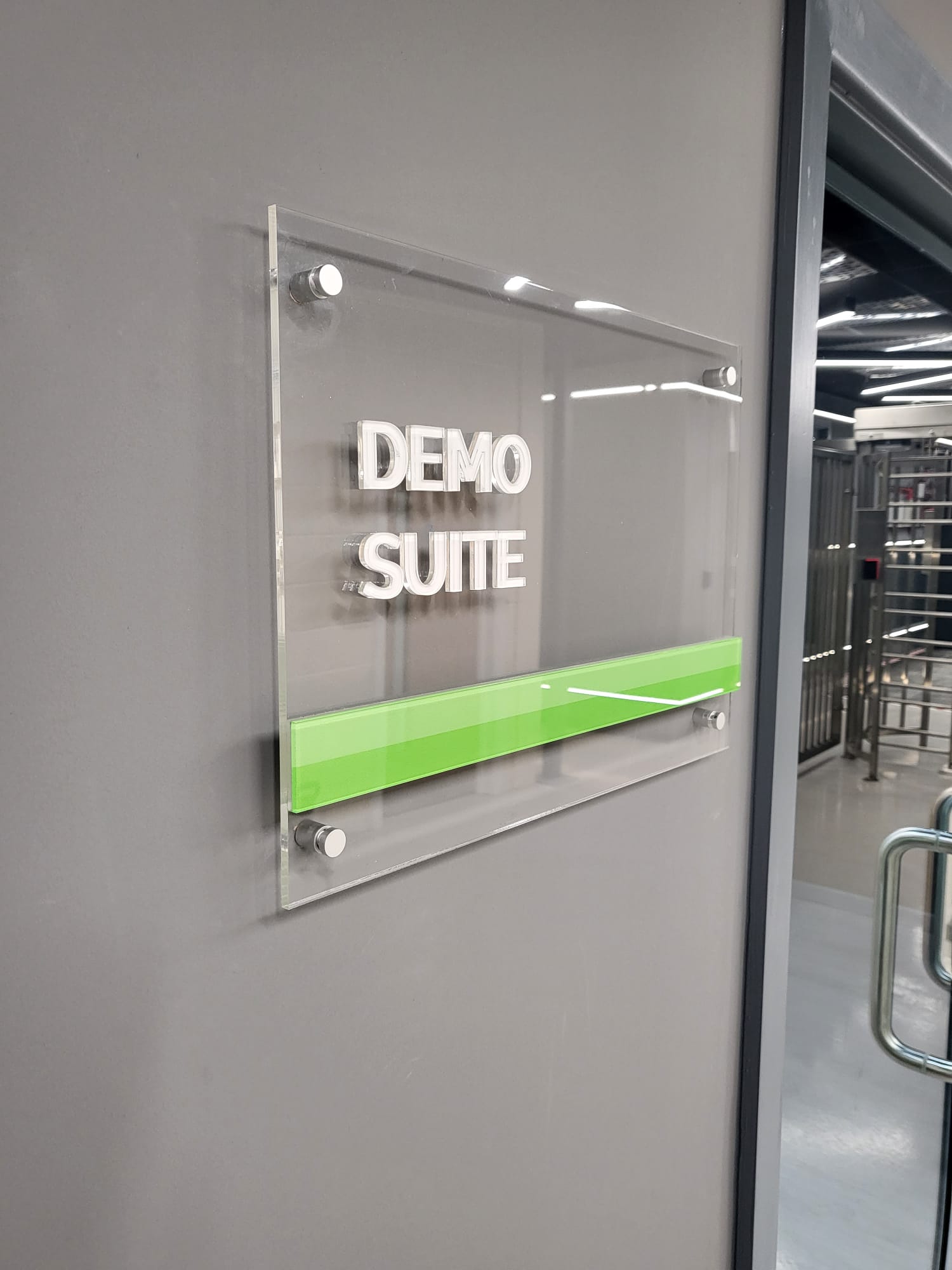 Custom acrylic office door plaque mounted next to the door